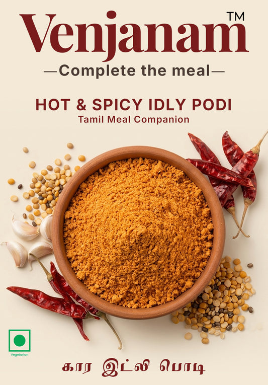 Venjanam Hot & Spicy Idly Podi packaging with a bowl of spice, red chilies, and garlic on a light background.