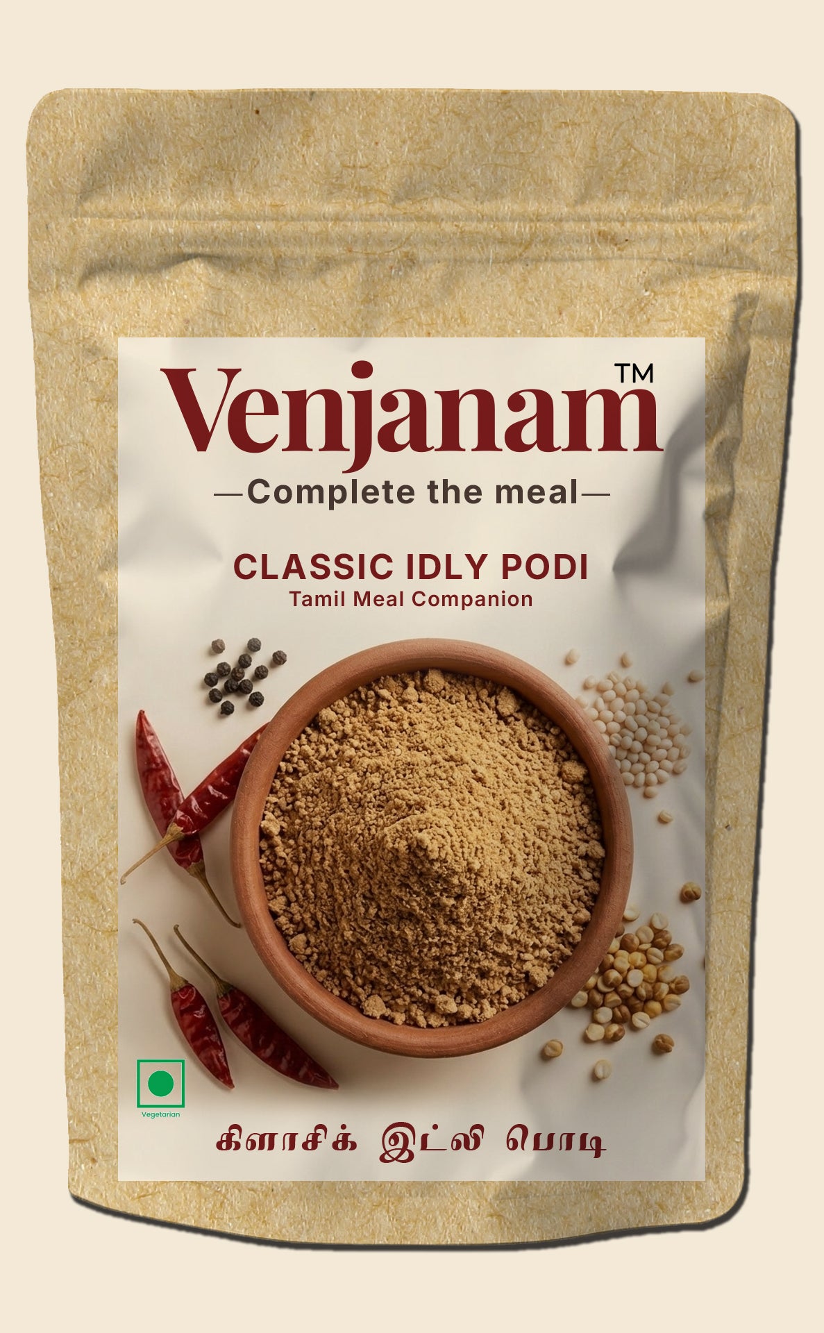 Venjanam Classic Idly Podi packaging with a bowl of spice and chili peppers on a beige background