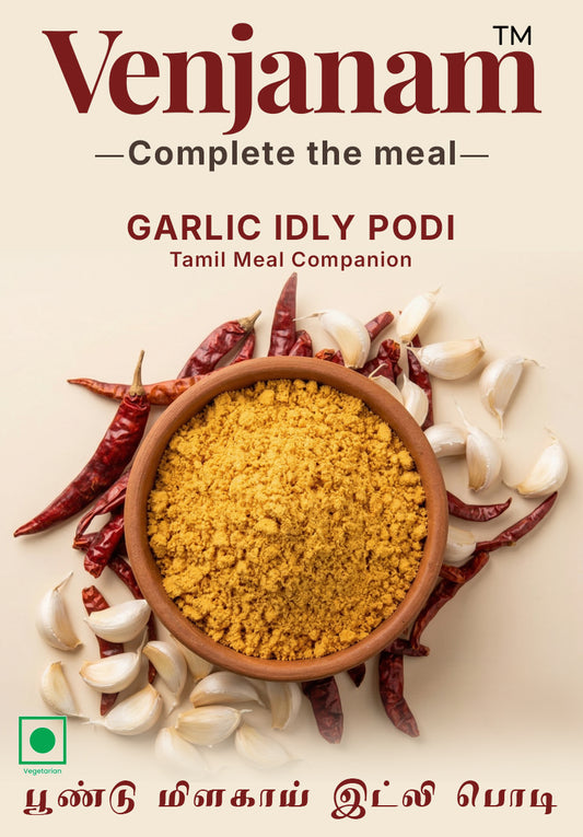 Venjanam Garlic Idly Podi packaging with garlic and red chili peppers on a beige background