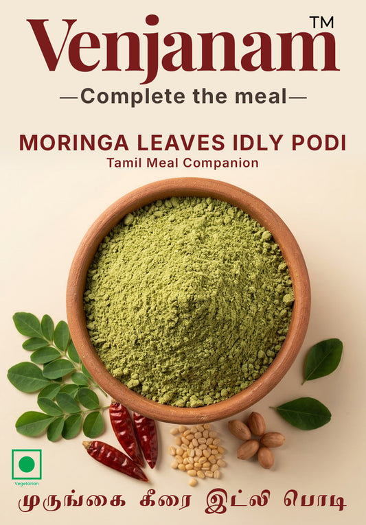 Moringa leaves idly podi in a wooden bowl with ingredients on a beige background, featuring the brand 'Venjanam'.
